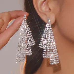 Detail of silver long tassel rhinestone earrings with layered geometric fringe design