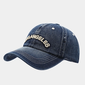 Detailed close-up of Los Angeles white embroidery on vintage blue denim baseball cap