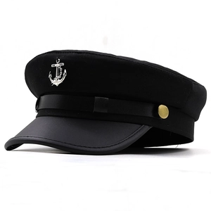 Detailed close-up of a black sailor cap with silver anchor badge and gold side buttons