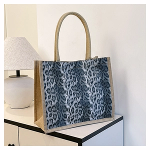 Detailed macro view of the leopard print panel and natural jute texture on the tote bag