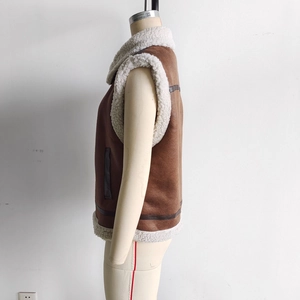 Detail of brown suede vest with white faux shearling lining and side leather accents