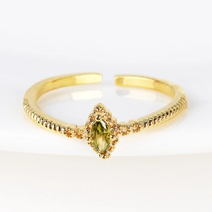 Detail of adjustable gold ring with green marquise stone and spiral texture