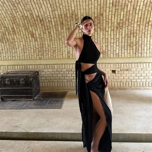 Detail view of the sexy backless halter dress featuring waist cut-outs and a high side slit