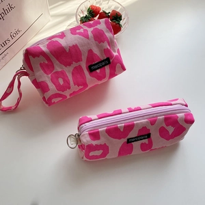 Pink leopard print corduroy pencil case and pouch set with black woven logo labels