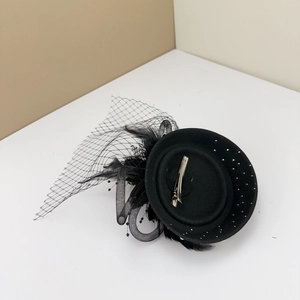 Bottom view of vintage black fascinator hat with feather mesh and metal clip