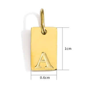 Macro shot of 18K gold plated rectangular initial A pendant showing 1cm x 0.6cm dimensions