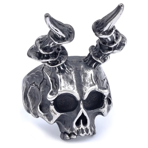 Detailed close-up of retro punk skull ring featuring horn textures and oxidized steel