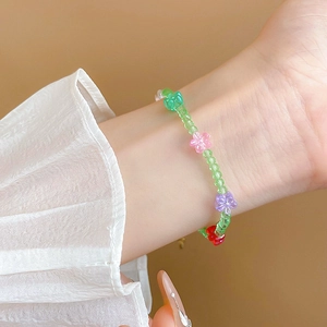 Detail of sweet floral beaded bracelet with colorful crystal petals on a model wrist