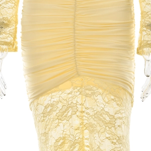 Detail of ruched yellow dress with elegant lace fabric texture and waist pleat design