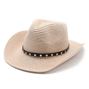 Detail of beige straw cowboy hat featuring a black band with silver metal rivets