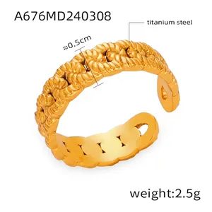 Detail of 0.5cm wide gold-plated twisted rope chain ring in titanium steel
