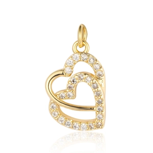 Close-up of golden heart-shaped pendant with cubic zirconia on white background