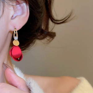 Close-up of model wearing red acrylic petal earrings with sparkling zircon inlay
