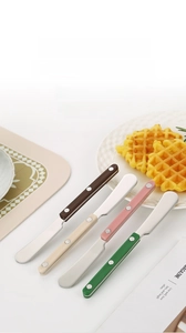 Close-up of four colorful 304 stainless steel butter knives with triple-rivet ABS handles