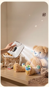 Handheld garment steamer showing steam flow on a teddy bear for 99.99% sterilization
