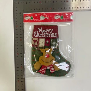 Detailed view of a green Christmas stocking with reindeer motif and 20x30cm measurement ruler