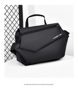 Detail of black motorcycle messenger bag featuring geometric flap and textured finish