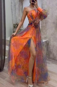 Detail of one-shoulder floral maxi dress with high slit and gradient mesh fabric
