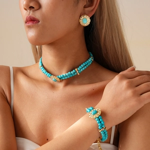 Detailed view of turquoise bead jewelry set including necklace, earrings and bracelet