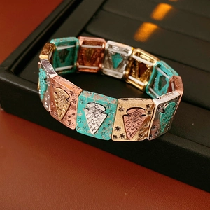 Detail of vintage bohemian elastic bracelet featuring turquoise blue and metallic modules