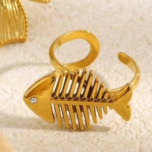 Macro detail of 18K gold plated stainless steel fishbone ring with crystal accent