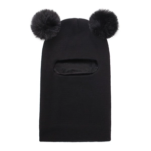 Close-up of black knitted baby balaclava featuring plush faux fur double pom poms