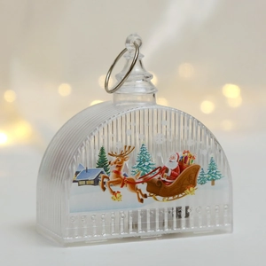 Close-up of LED Christmas lantern featuring Santa Claus and reindeer scene with metal loop