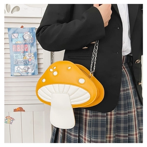 Close-up of cute yellow mushroom crossbody bag with silver chain on schoolgirl outfit