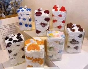 Detail of assorted fruit mousse scented candles in glass jars with realistic cream toppings