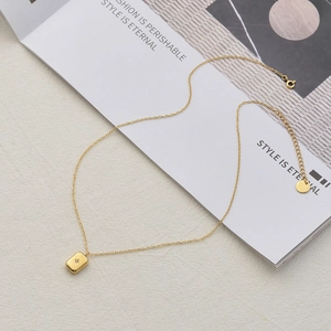 Gold plated stainless steel necklace with square bar pendant featuring star engraving