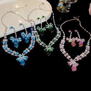 Detailed view of zircon jewelry sets with necklaces and earrings in blue green and pink