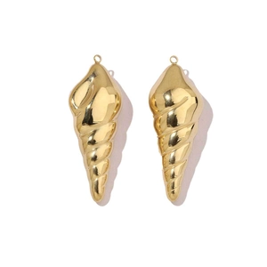 Macro shot of mirror-polished golden conch pendants for DIY jewelry making
