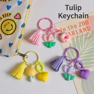 Three creative tulip resin keychains in pink, yellow and purple with tassels for bags