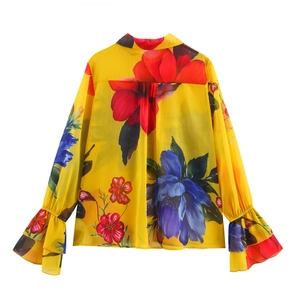 Back view of yellow floral chiffon blouse with bell sleeves and large flower print