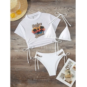 Detailed flat lay of white three-piece bikini with mesh cover-up and beach graphic print