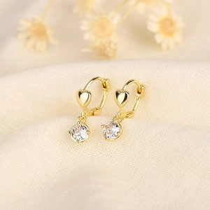 Elegant S925 silver heart earrings with zircon drops on a soft beige knit fabric