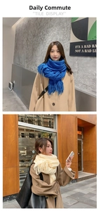 Detail of royal blue and off-white winter scarves with soft tassels in two styles