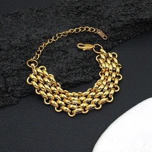 Macro detail of multi-layered gold corn chain bracelet with lobster clasp and K18 tag