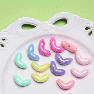 Macro detail of colorful pearlescent moon-shaped resin beads for DIY jewelry making