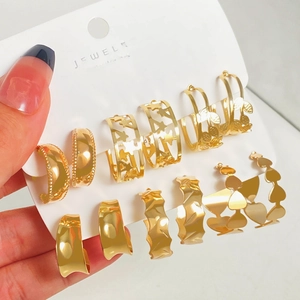 6-pair set of gold geometric hoop earrings with heart, butterfly, and leaf motifs on card