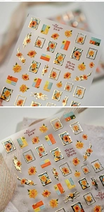 Detail of sunflower nail stickers with gold embossed foil and retro stamp design