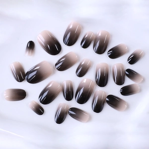 Short oval almond press-on nails featuring glossy brown ombre gradient design