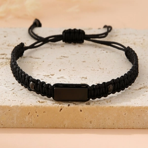 Detail of adjustable woven cord bracelet with black stainless steel plaque and bead accents