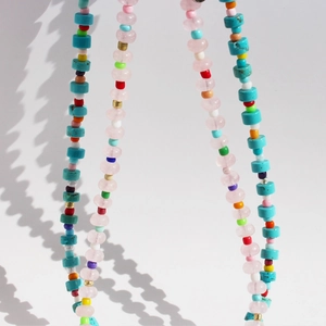 Rainbow beaded necklace with pink crystal and turquoise charms in a summer boho style