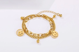 Close-up of golden double-layer chain bracelet featuring hollow star and moon charms