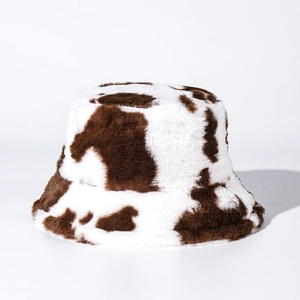 Detailed close-up showing the soft cow print faux rabbit fur texture of the winter bucket hat