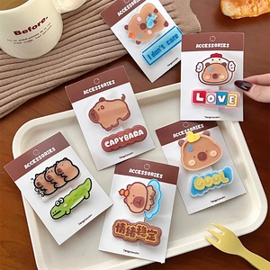 Detailed view of cute Capybara hair clips in earthy tones displayed on a white tray