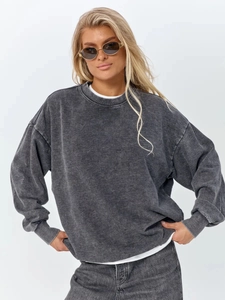 Detail of vintage washed grey cotton sweatshirt showing fabric texture and ribbed neckline