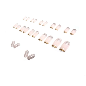 Pink matte press-on nails with golden curved edges and silver glitter gradient finish