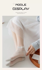 Detail of thin mesh lace boat socks with delicate white bow and elegant lace trim